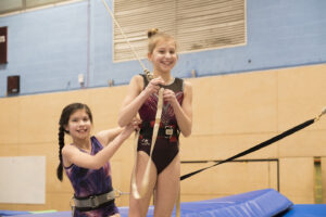 girls organising trampoline safety equipment. Trampoline courses for all. trampoline club.