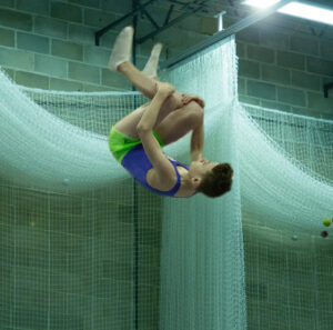 Young trampoline gymnast in action on a trampoline